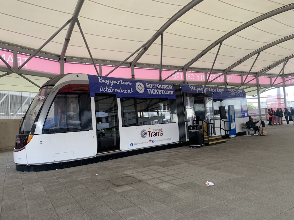 a white bus parked in a station