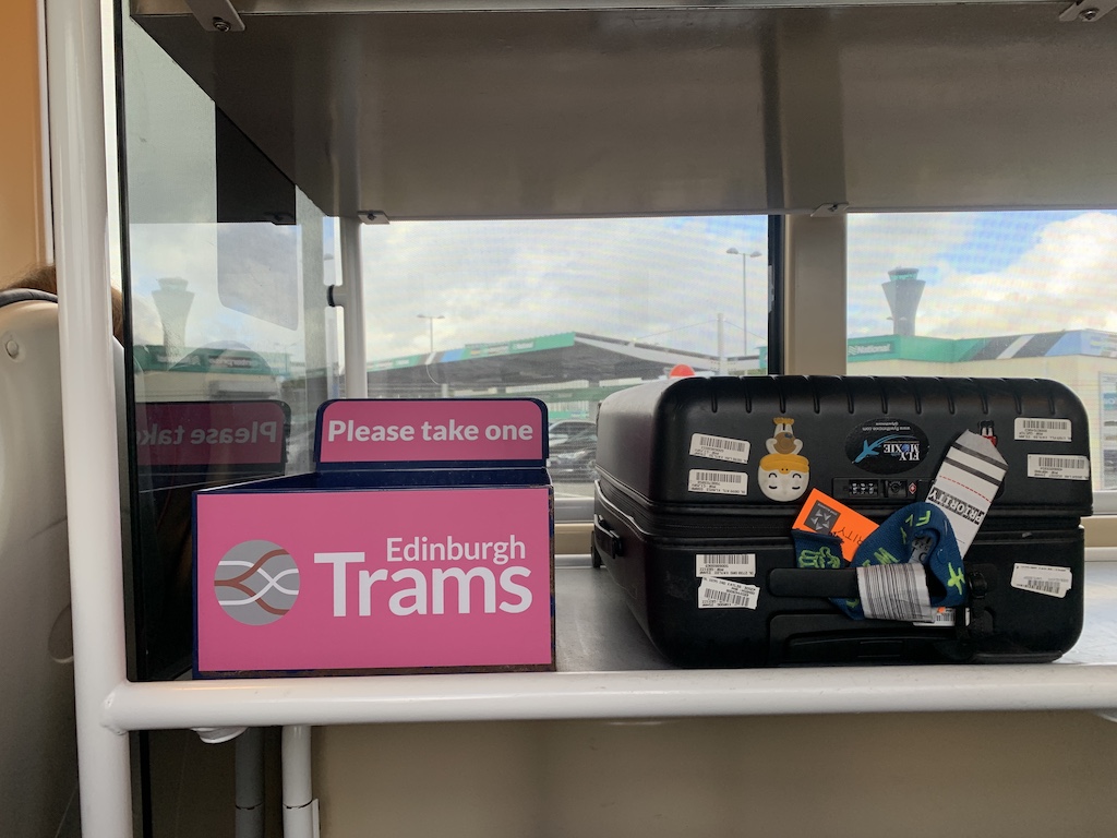 a suitcase and a sign on a shelf