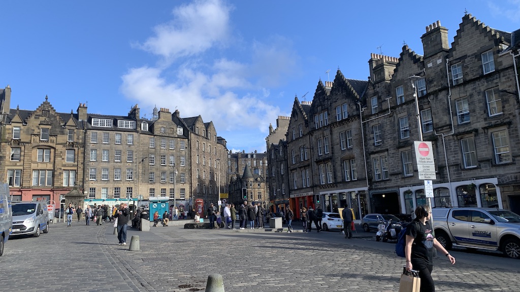 a group of people walking around a city