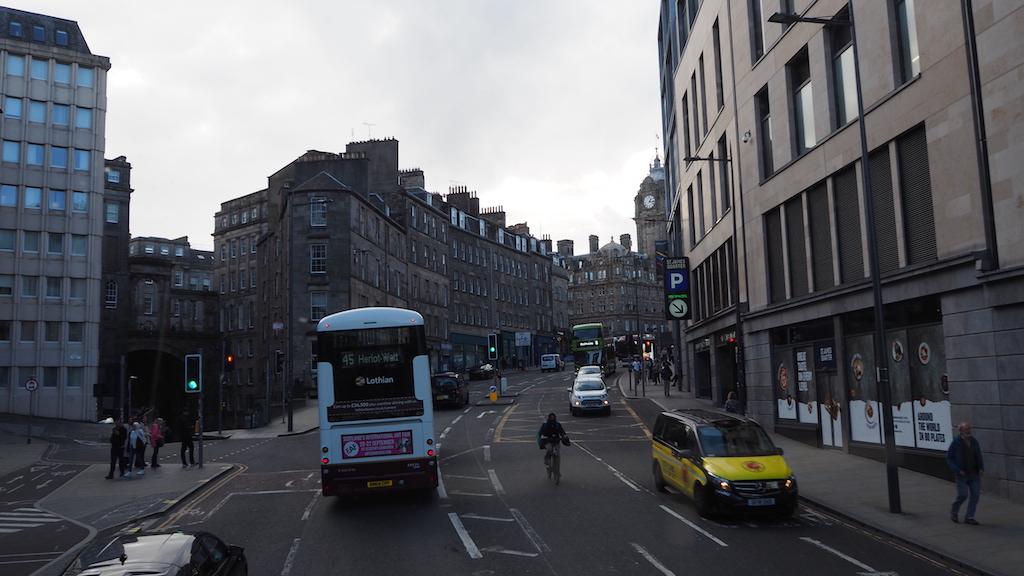 a city street with cars and people