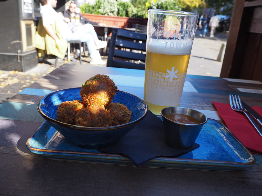 a plate of food and a glass of beer on a table