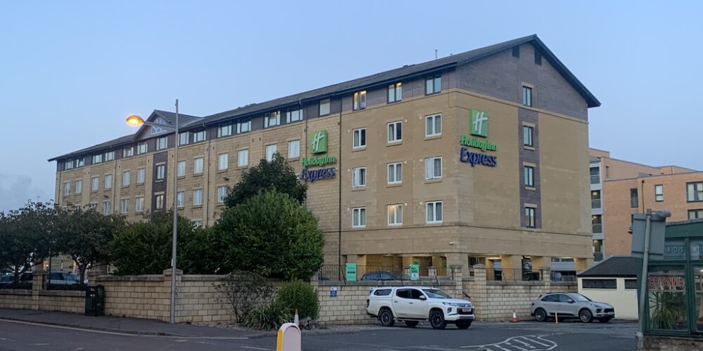 a building with cars parked in front