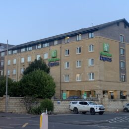 a building with cars parked in front