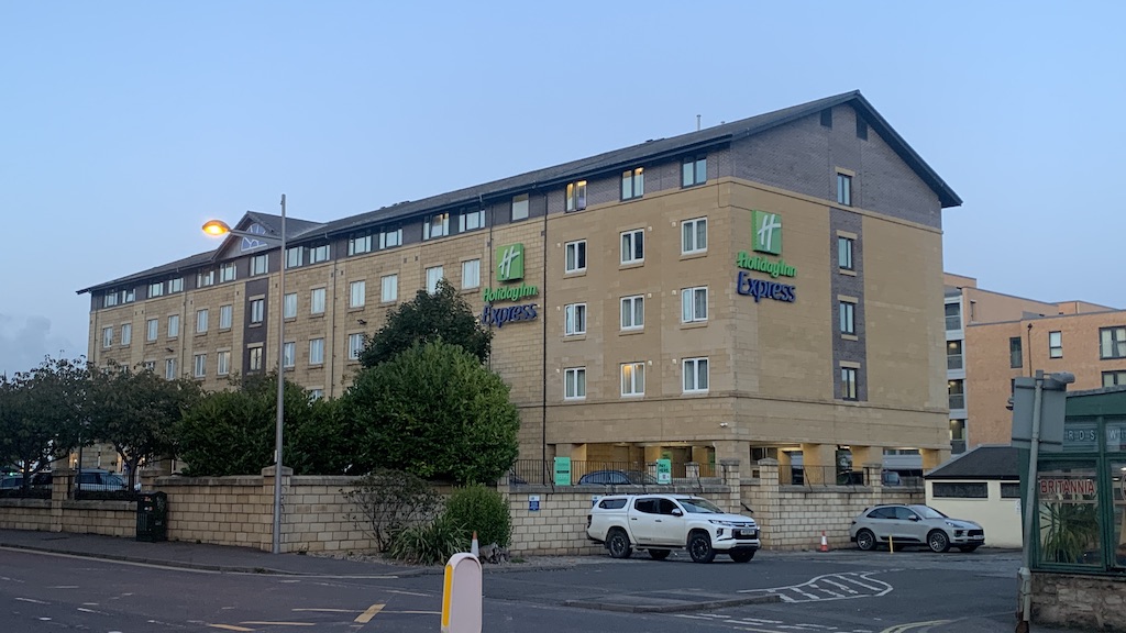 a building with cars parked in front