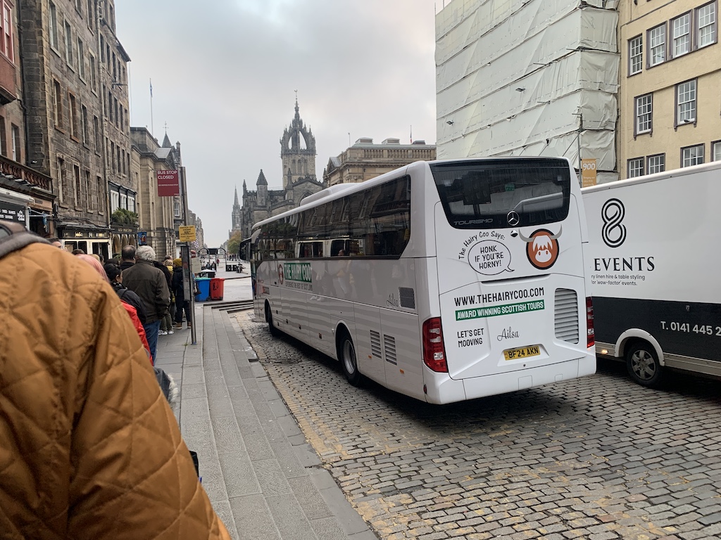 a white bus parked on the side of a street