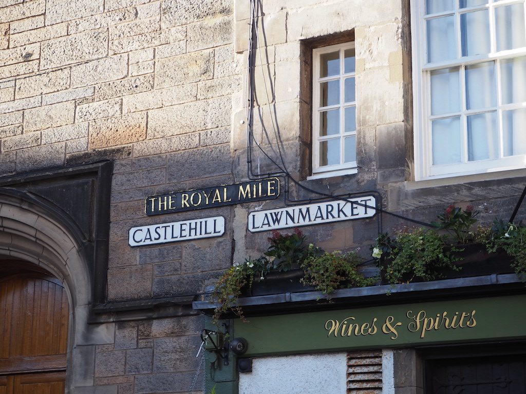 a street sign hangs from a building