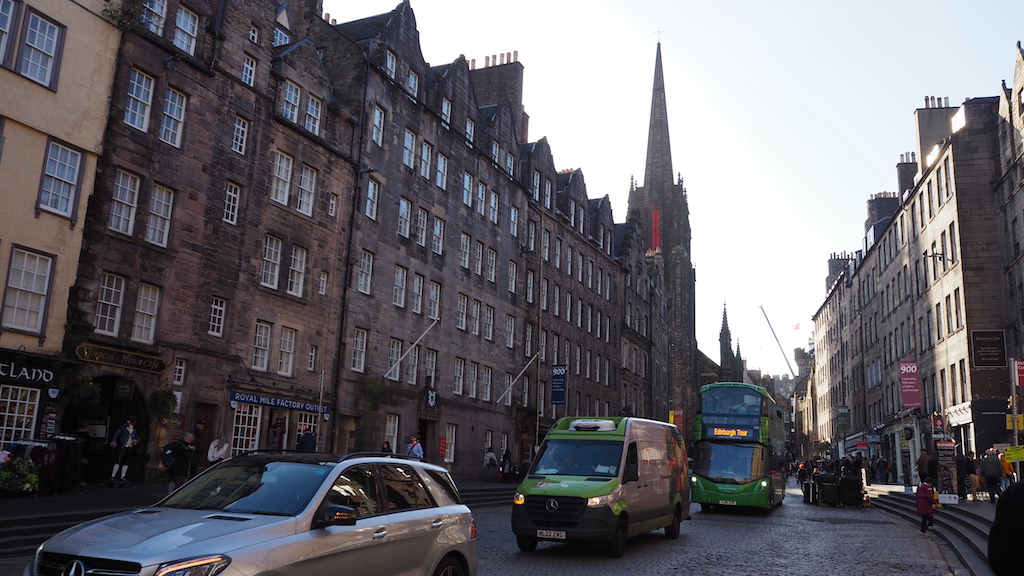 a city street with cars and buses