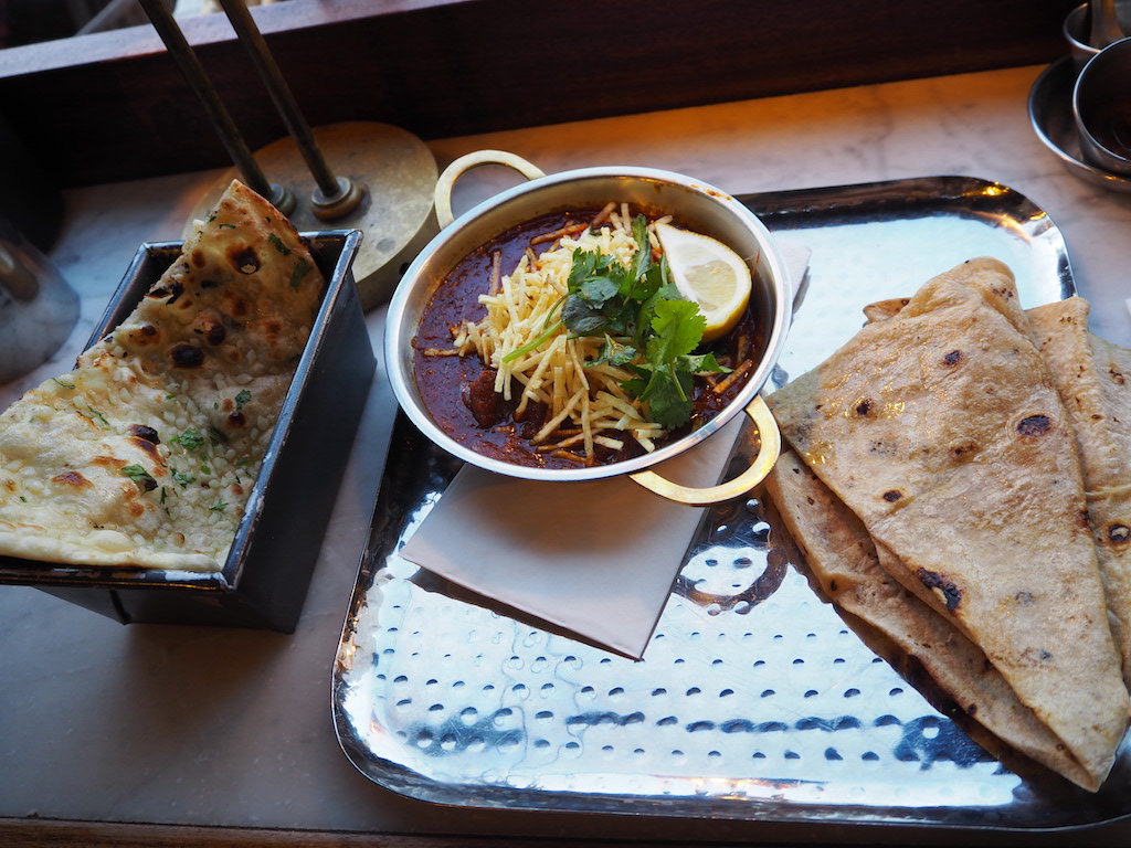 a bowl of soup next to a plate of food