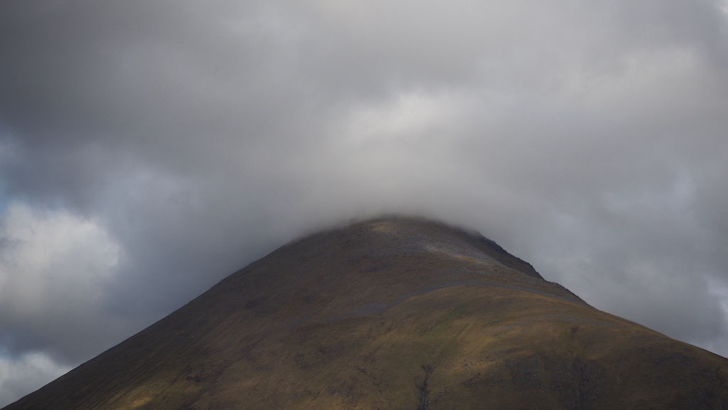 a hill with clouds above it