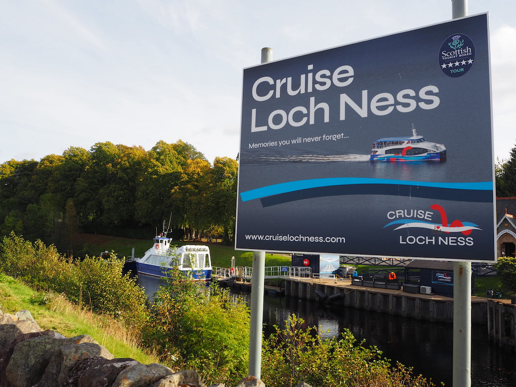 a sign with boats in the background