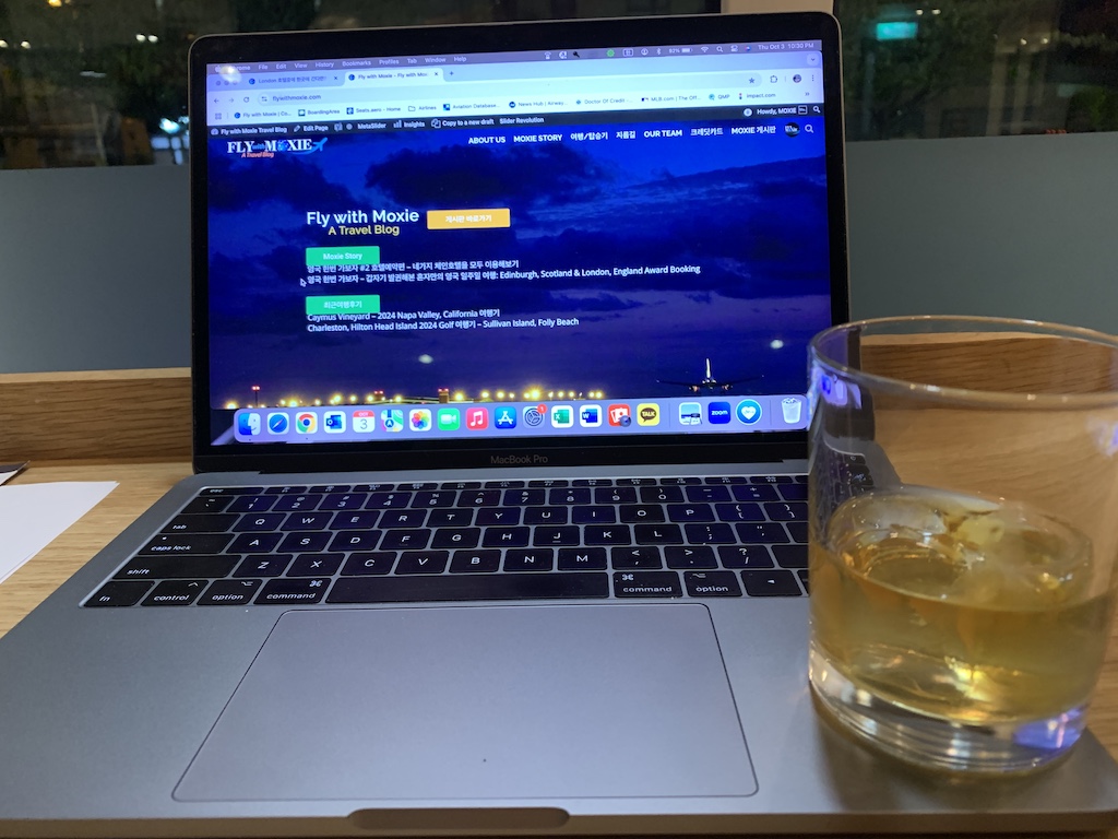 a laptop computer next to a glass of water