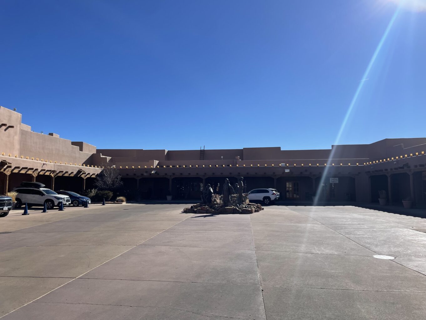 a parking lot with cars and a building in the background