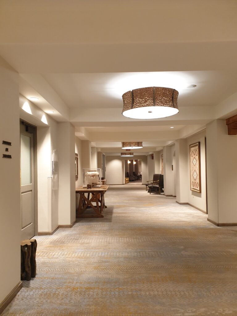 a long hallway with a table and chairs