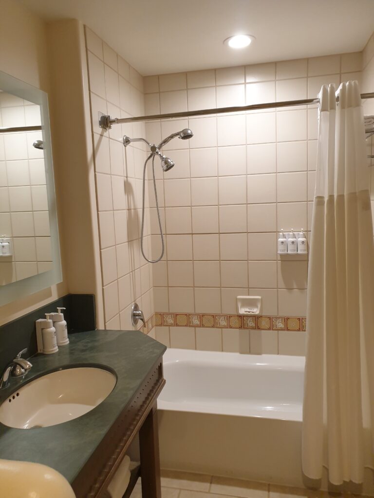 a bathroom with a sink and a shower unit