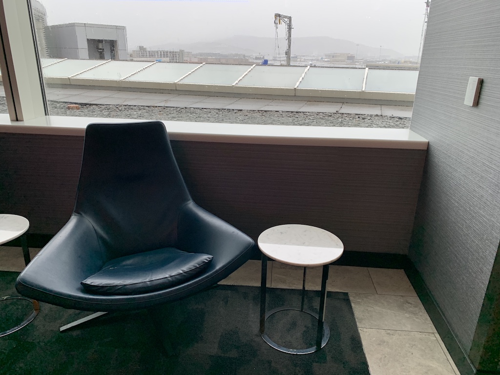 a chair and table on a balcony