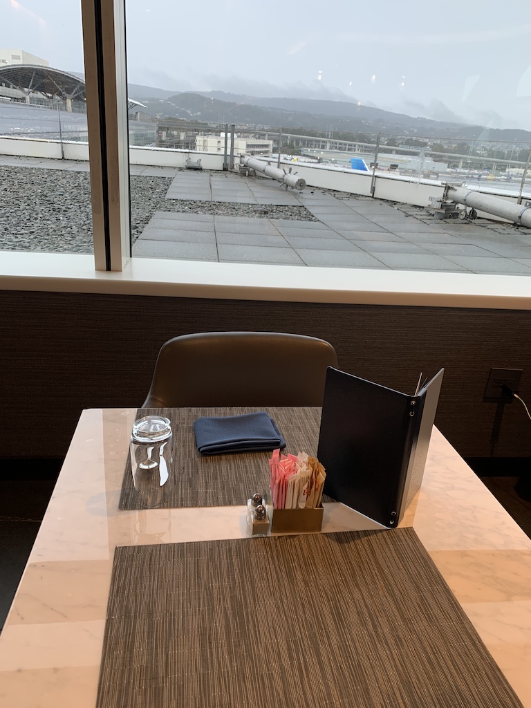 a table with chairs and a window overlooking a city