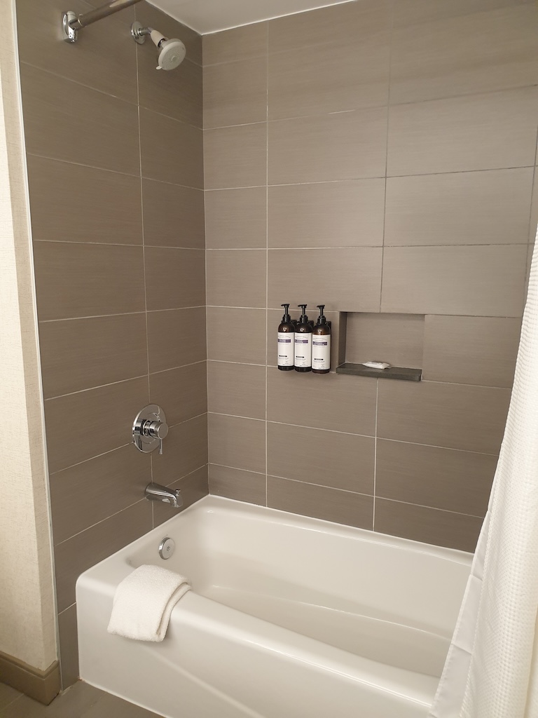 a bathroom with a bathtub and shower unit