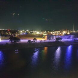 a body of water with a city in the background