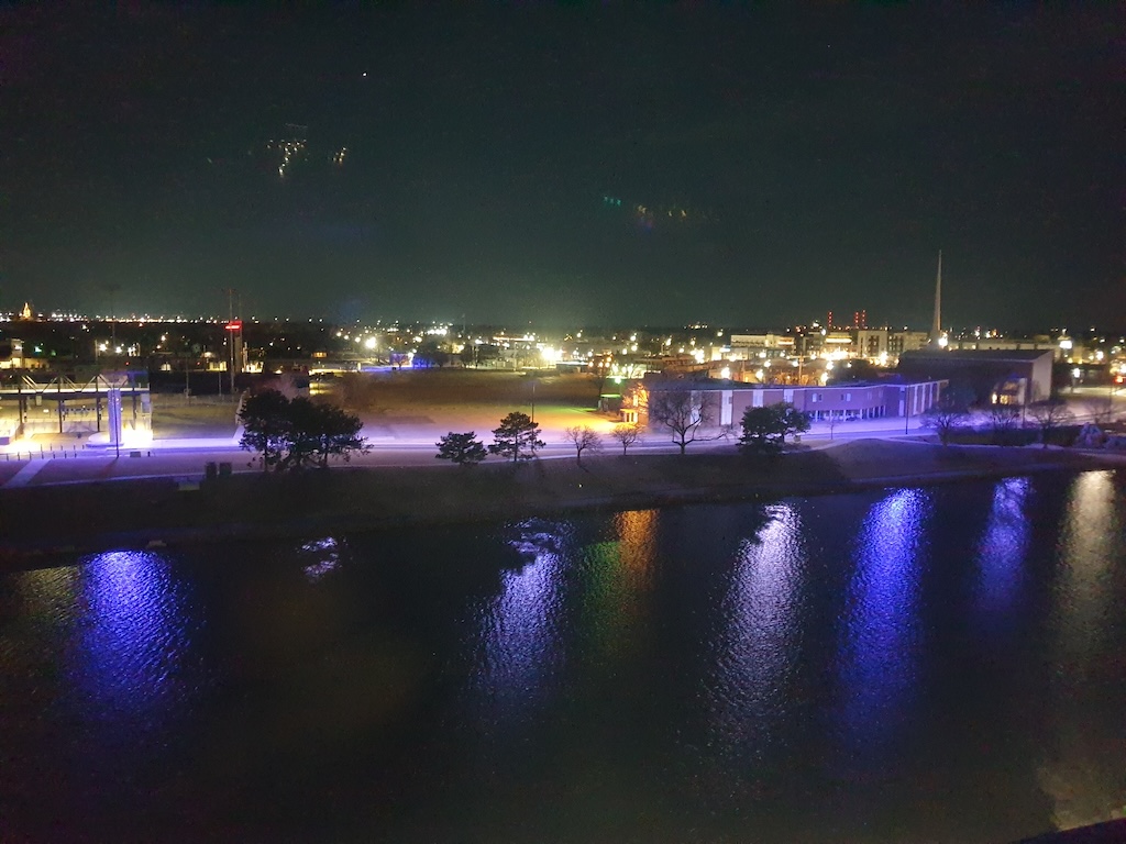 a body of water with a city in the background