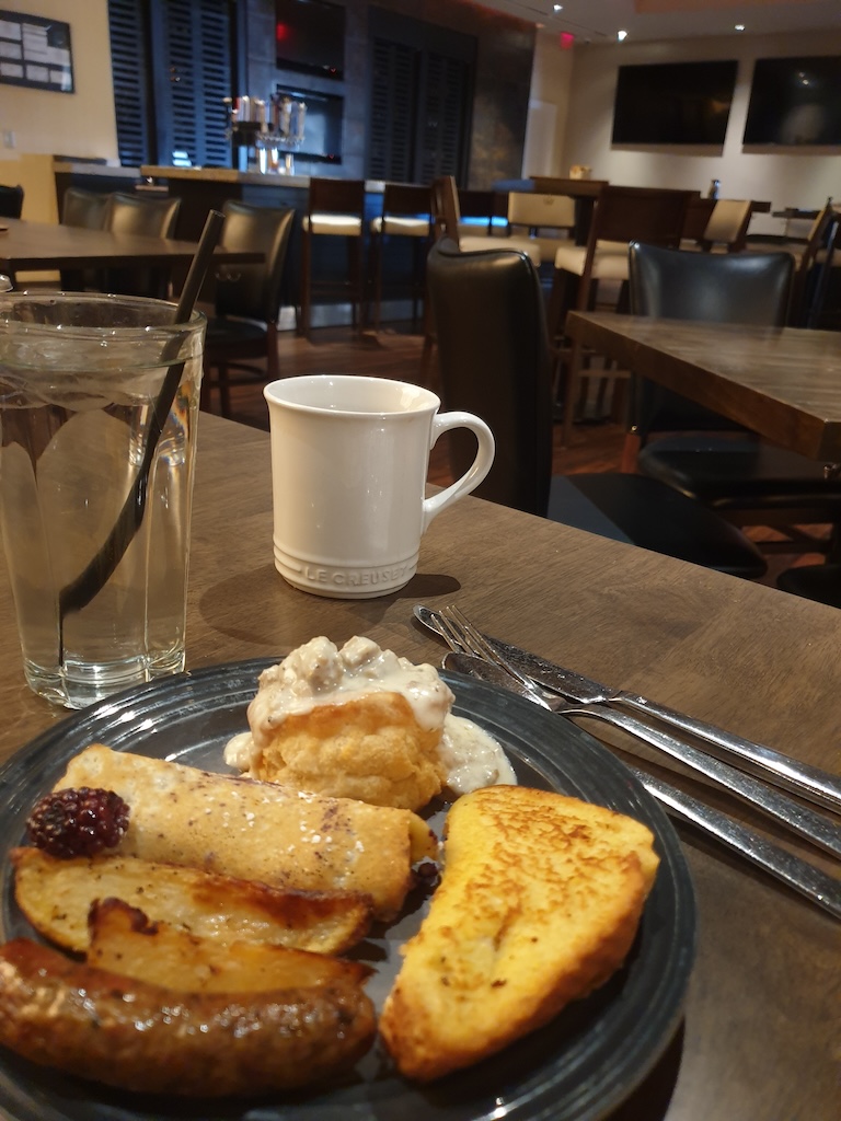 a plate of food and a cup of coffee