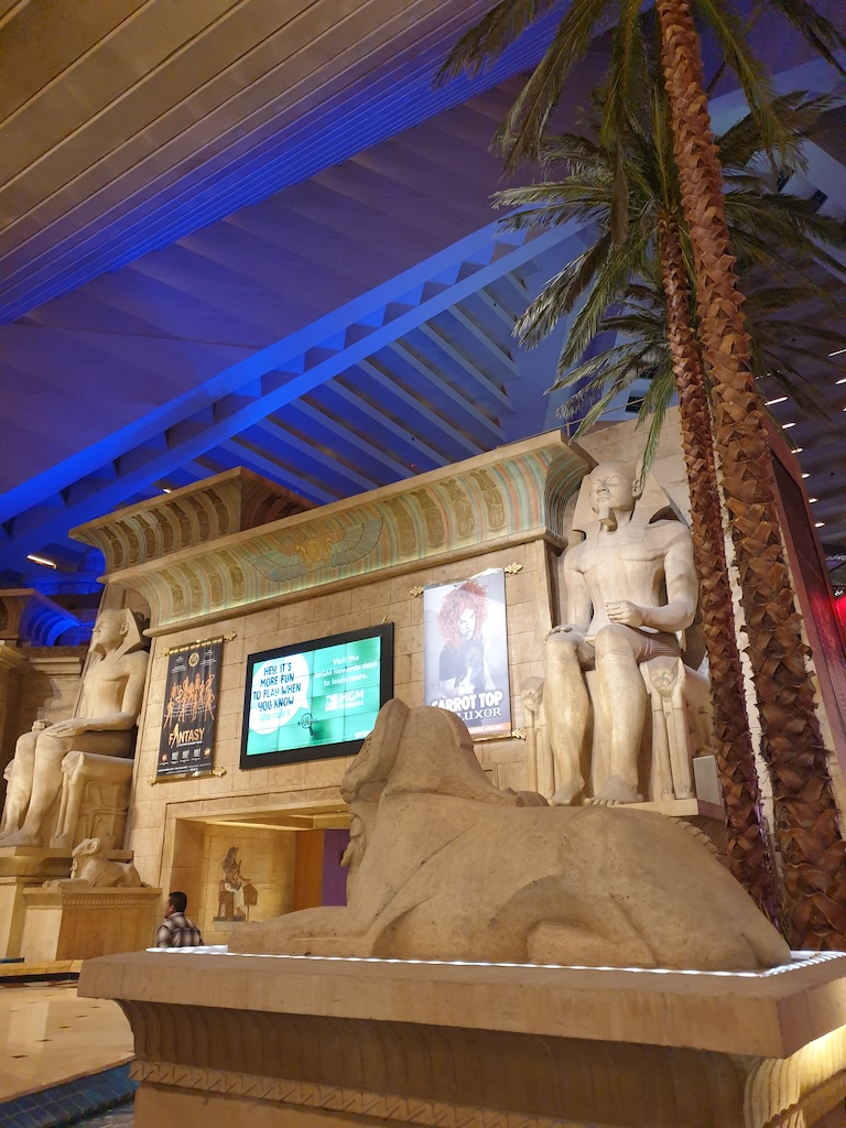 a statue of a man and a woman in a room with a large ceiling