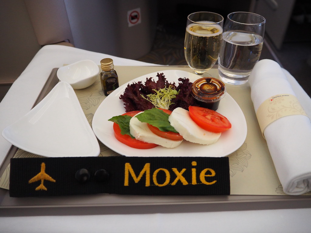 a plate of food and glasses of wine on a table