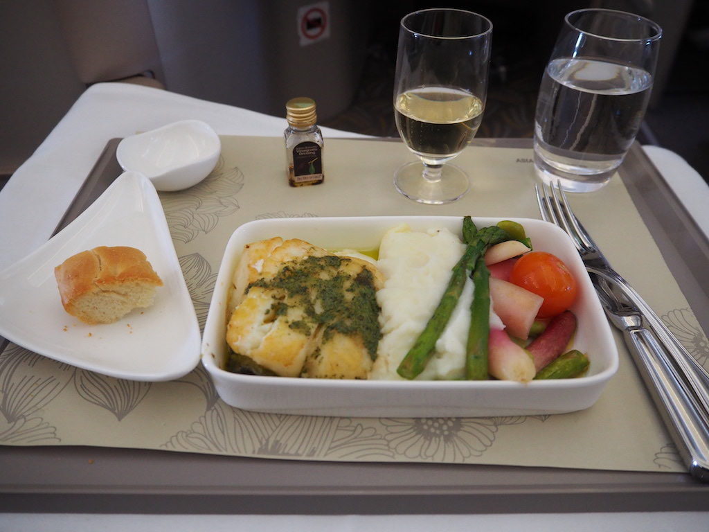 a plate of food and glasses of wine on a table