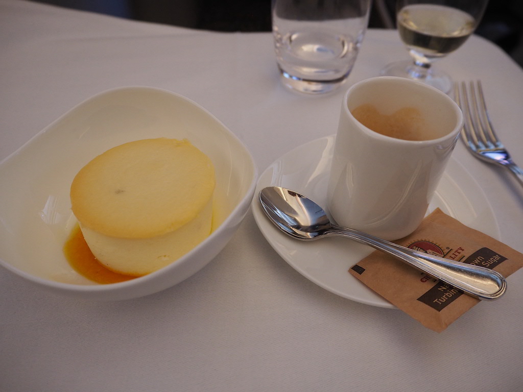 a bowl of food and a cup of coffee on a table