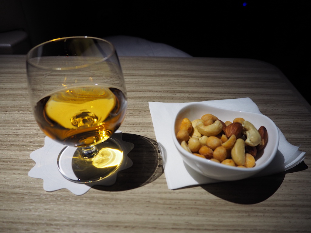 a plate of food and a glass of beer on a table