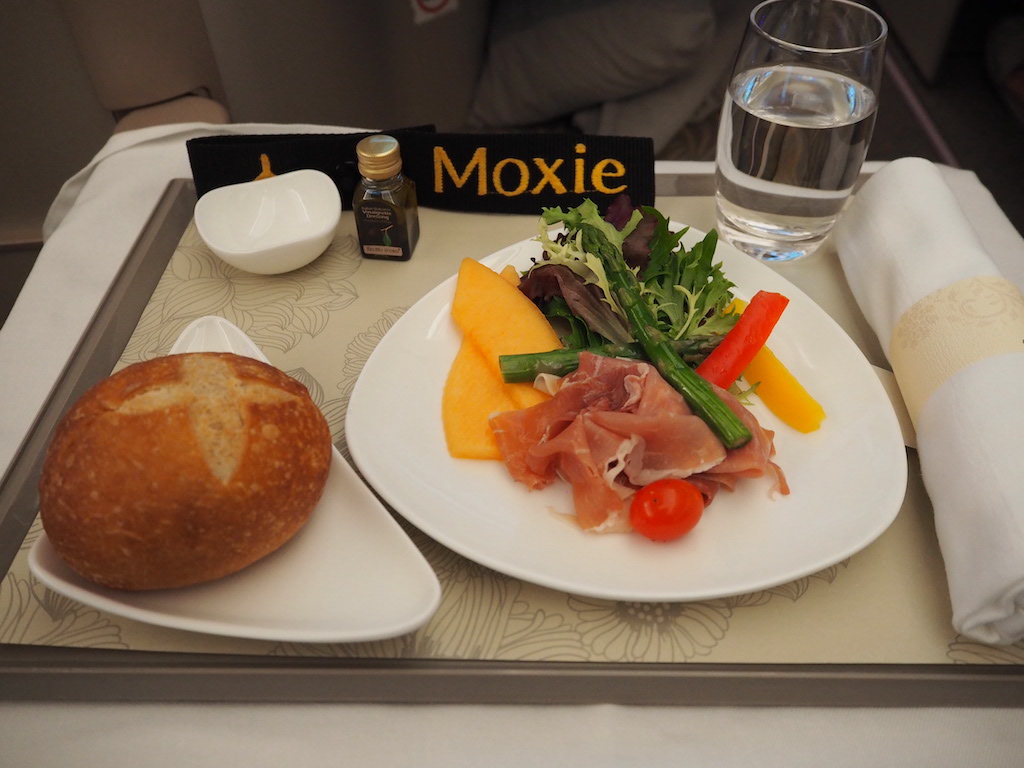 a plate of food and a glass of water on a table