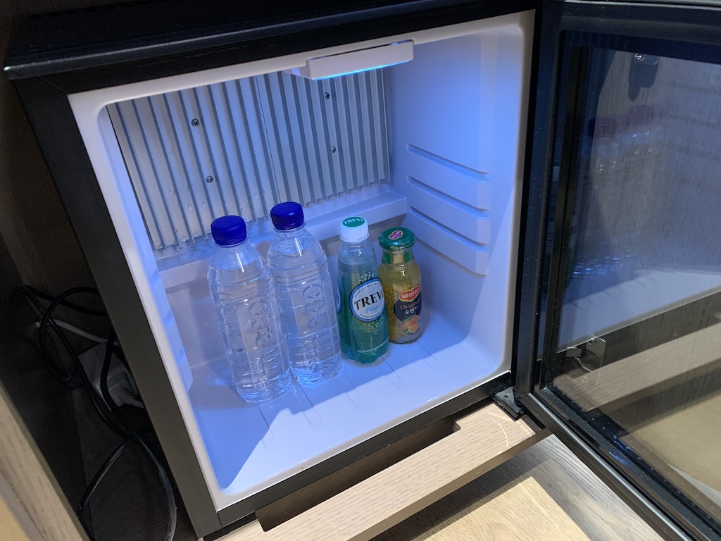 a refrigerator with water bottles