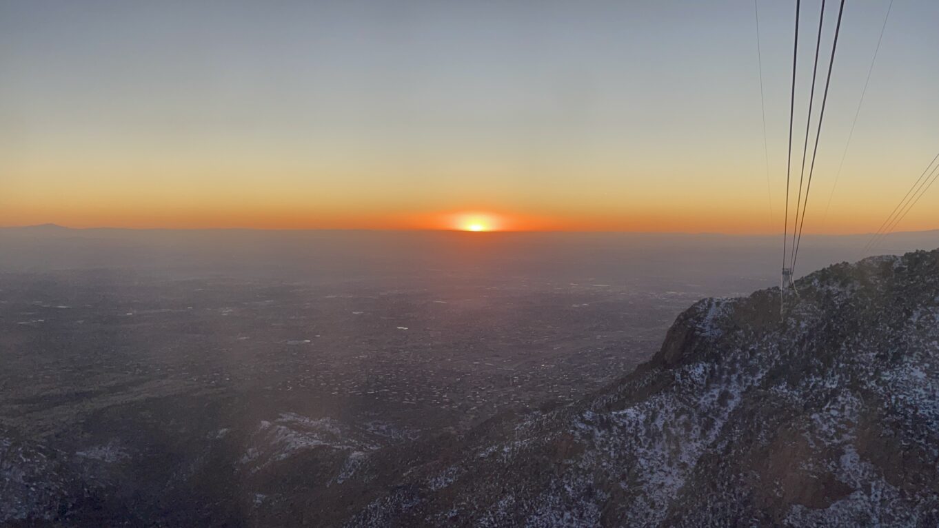 a sunset over a snowy landscape