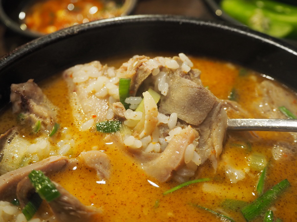 a bowl of soup with meat and vegetables