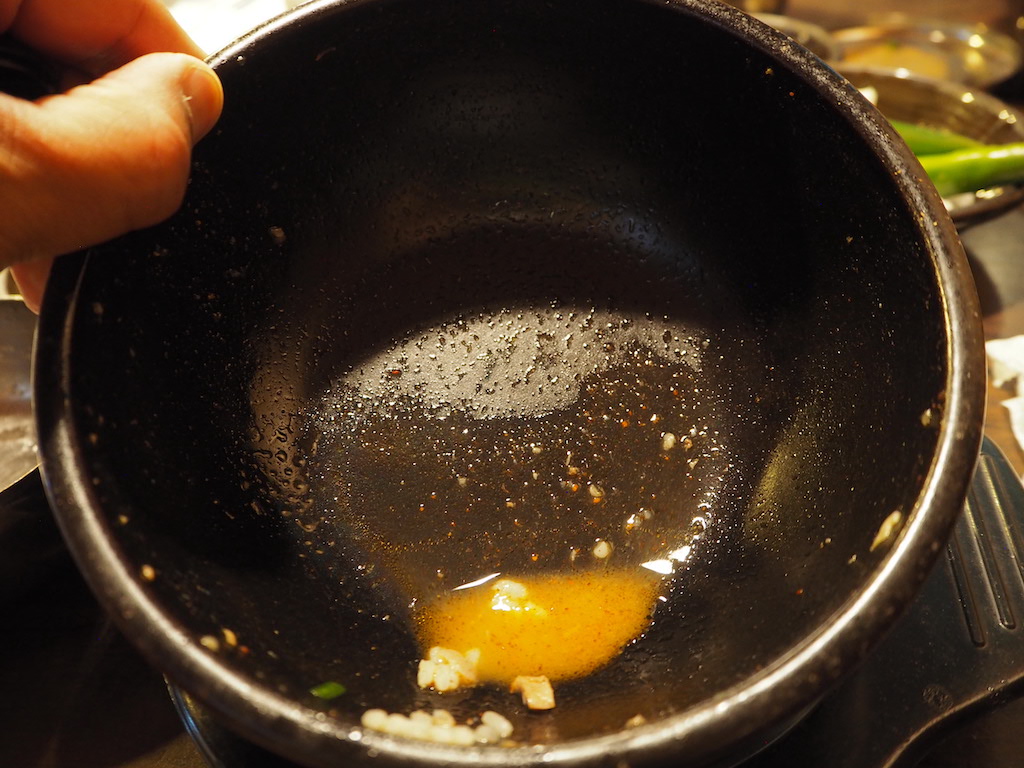 a person cooking food in a pan