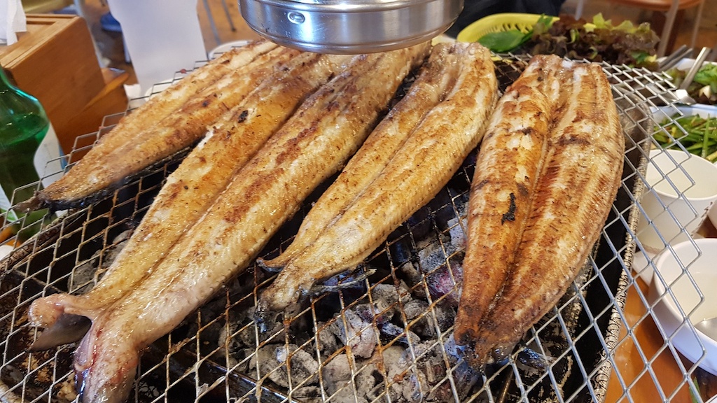 a group of fish on a grill