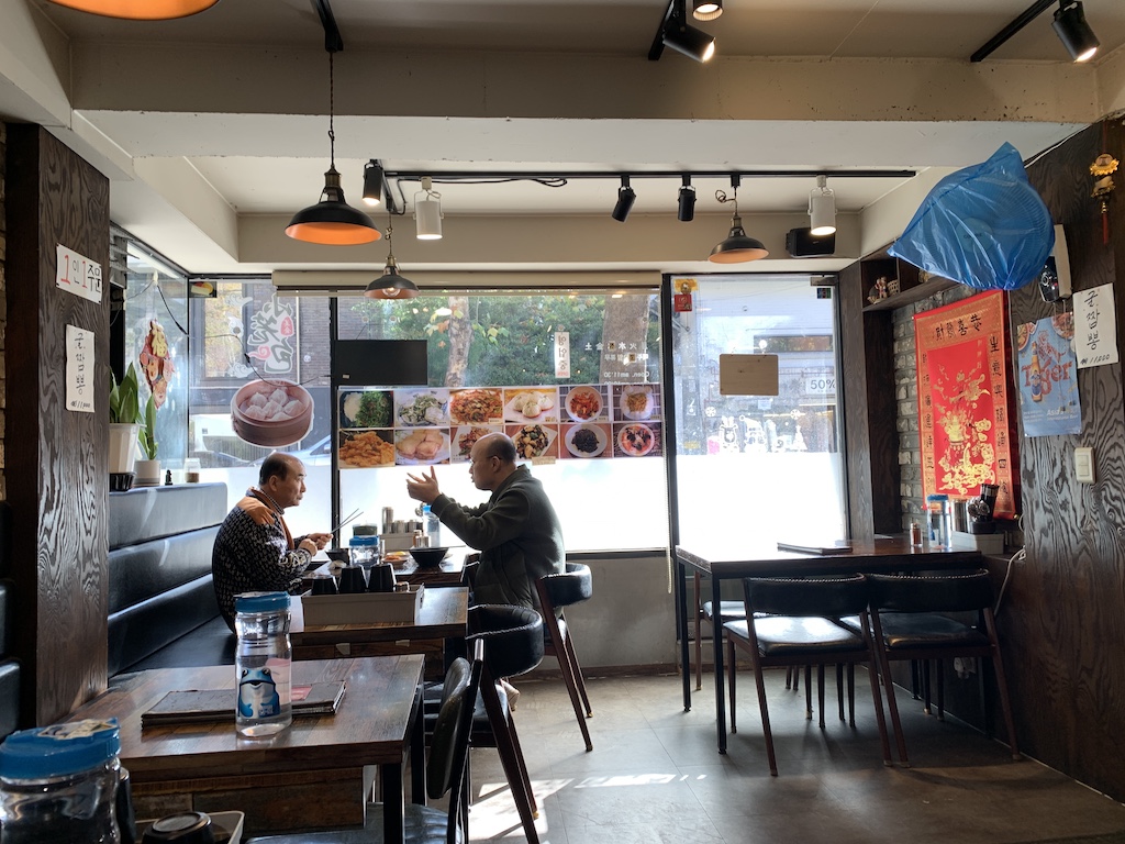 a couple of people sitting at a table in a restaurant