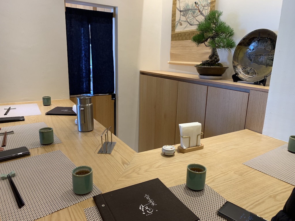 a table with a laptop and coffee cups on it