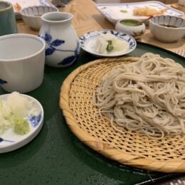 a basket of noodles and other dishes