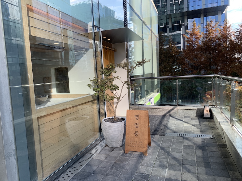 a potted tree outside a building