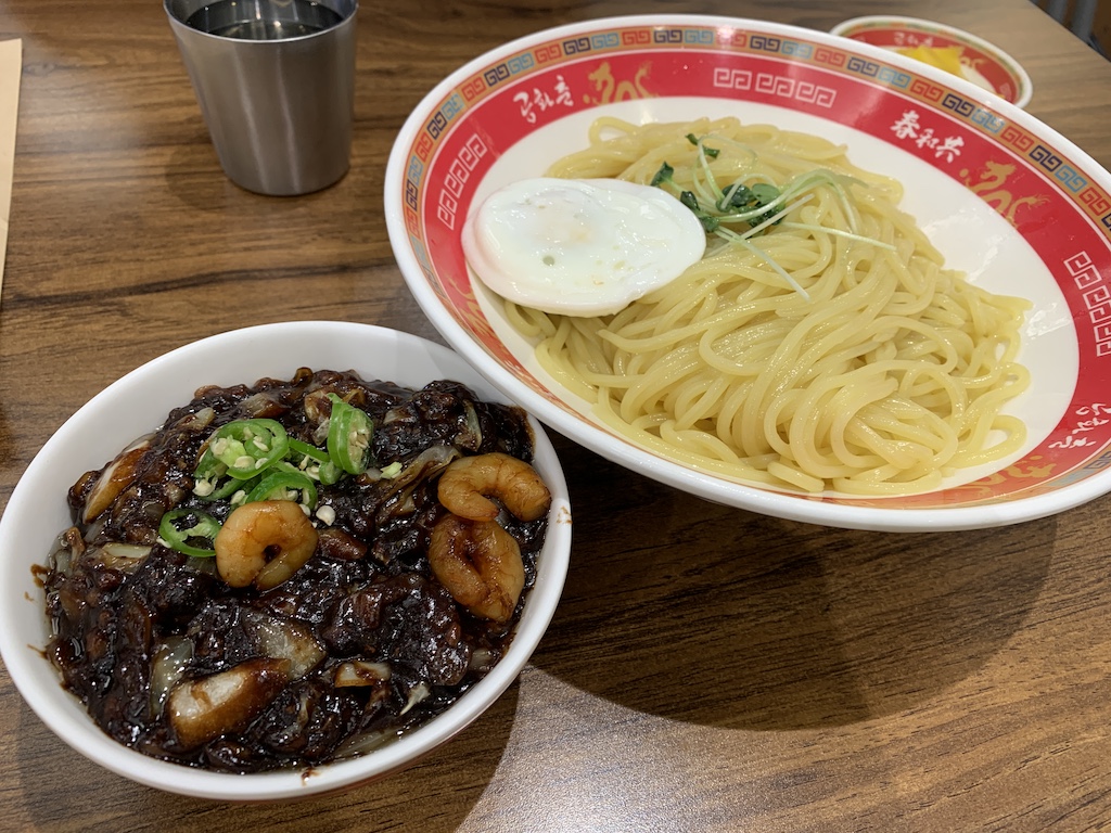 a bowl of soup and a bowl of noodles on a table