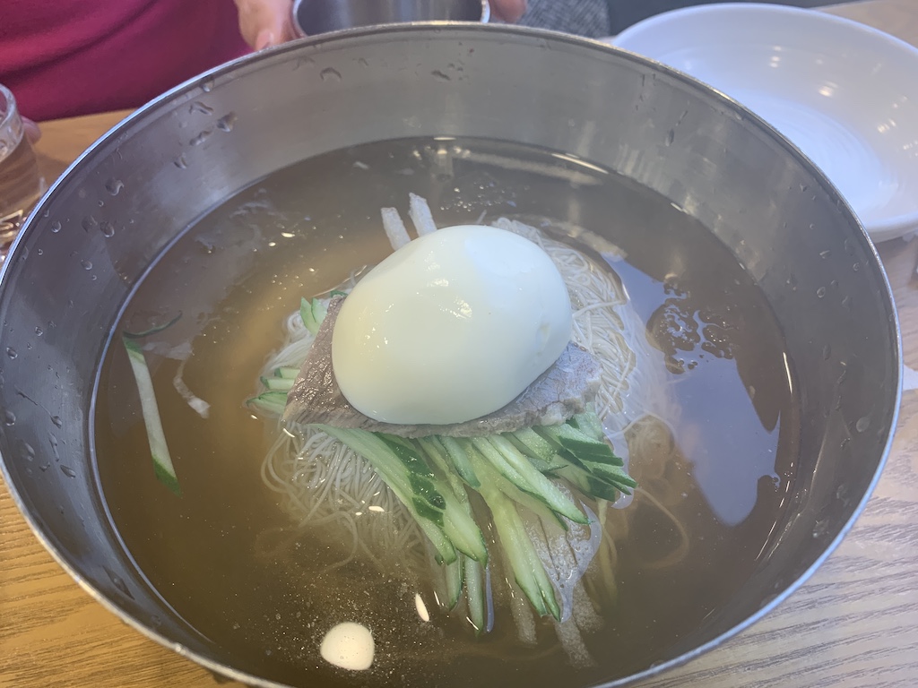 a white egg in a bowl of water