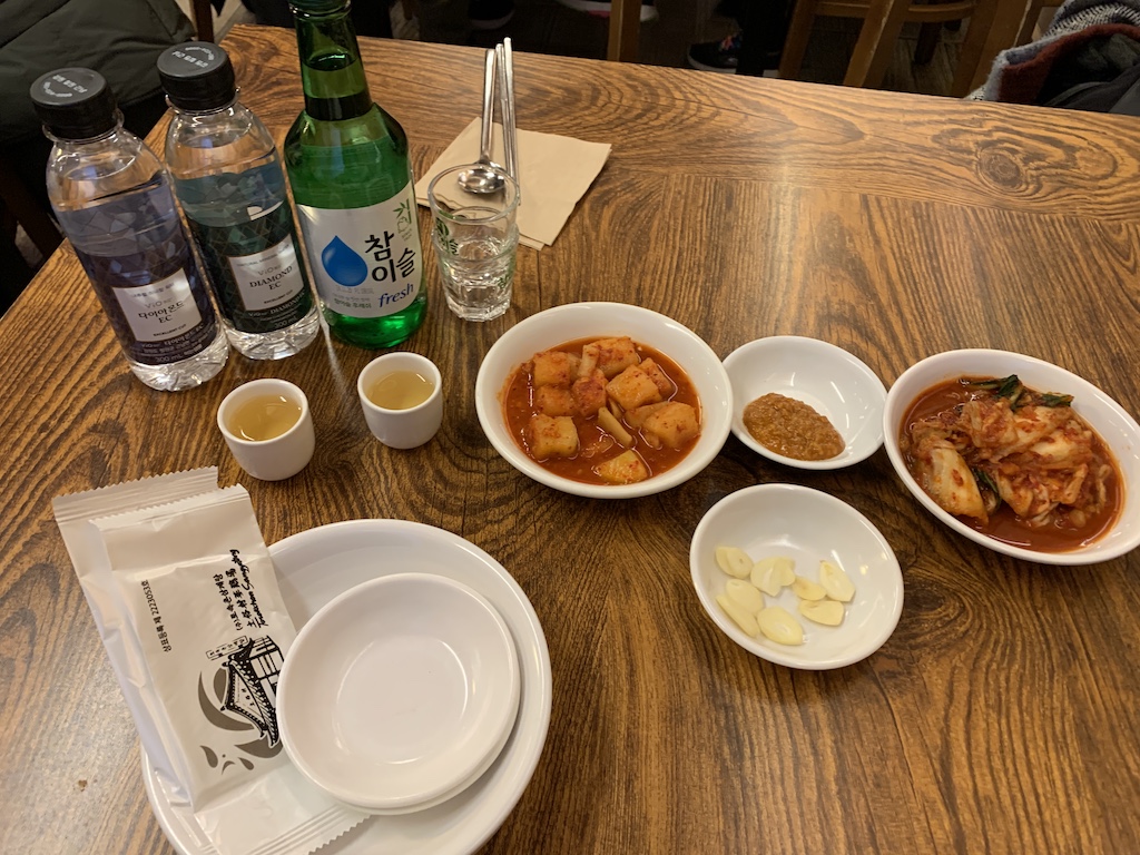 a table with plates of food and bottles of water