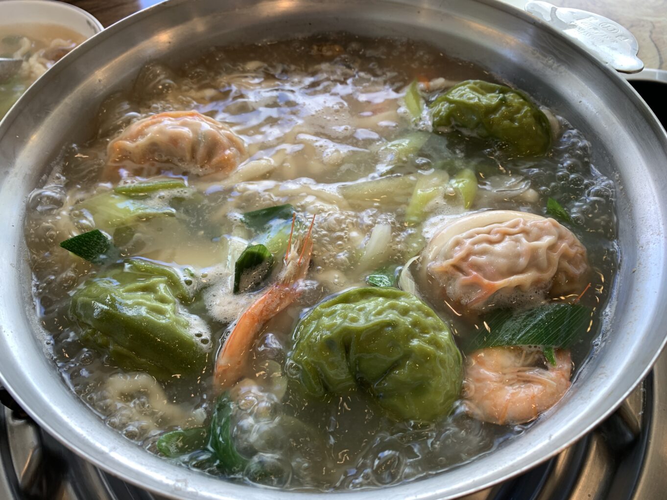 a bowl of soup with meat and vegetables