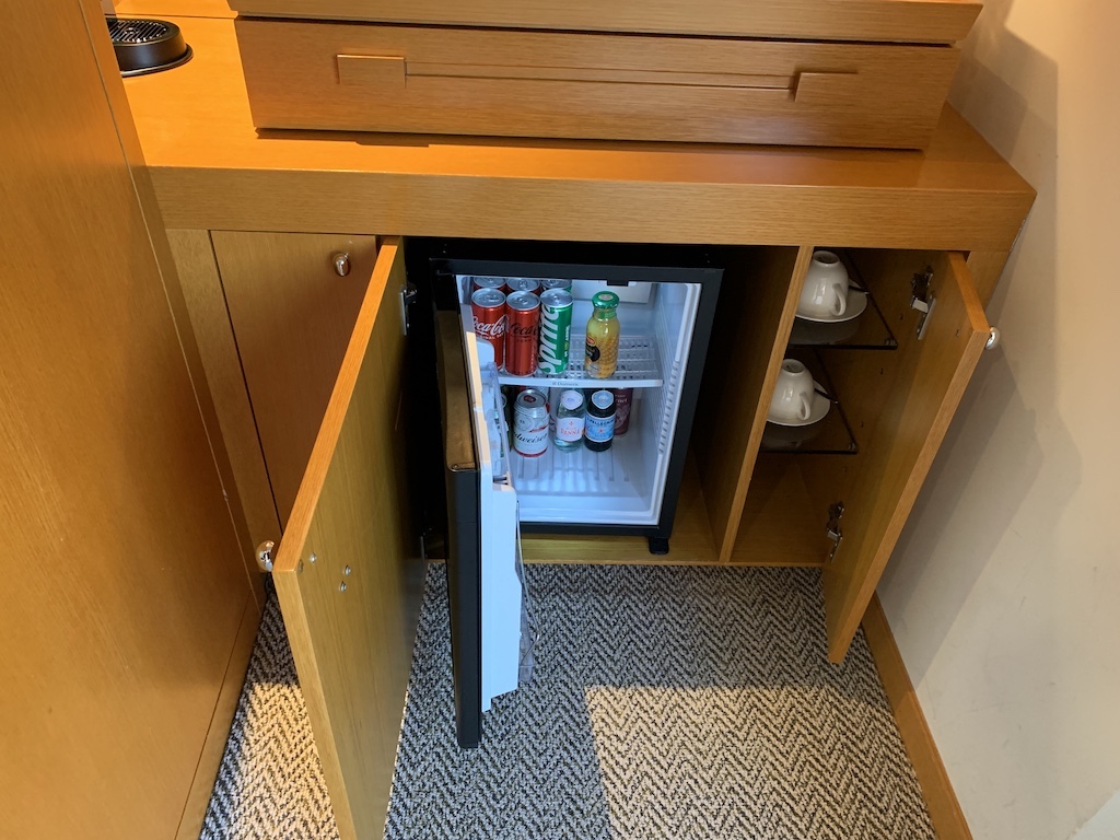 a cabinet with a shelf full of beverages