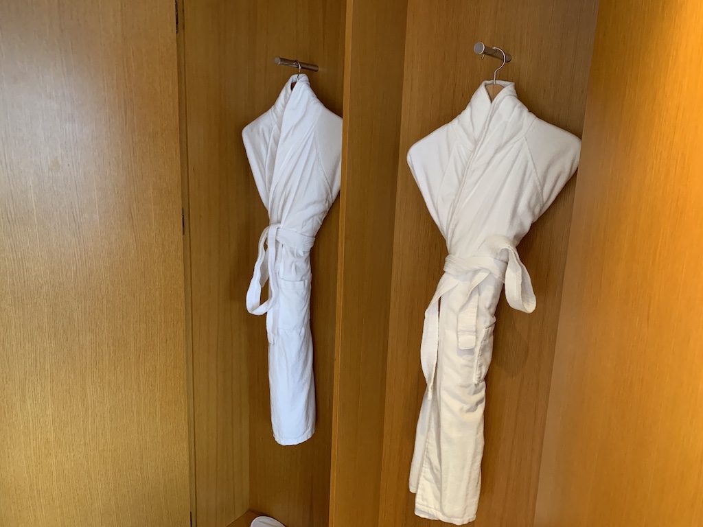 a pair of white shirts on a door