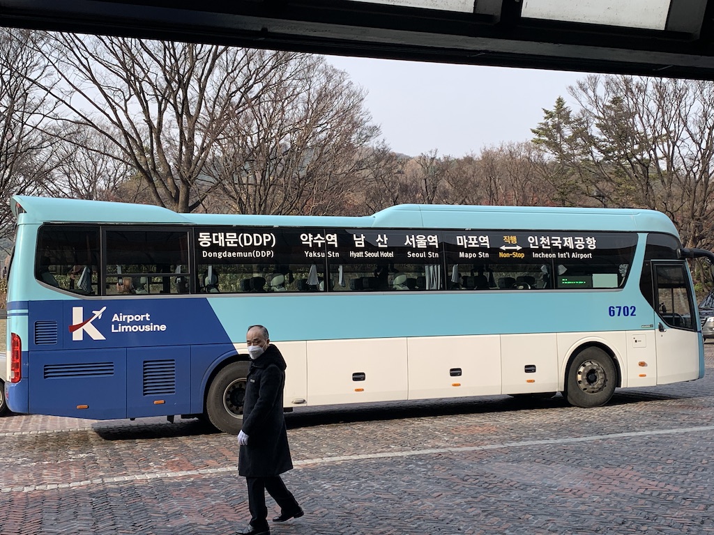 a person walking next to a bus