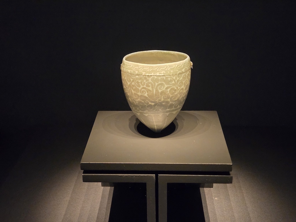 a white vase on a white stand