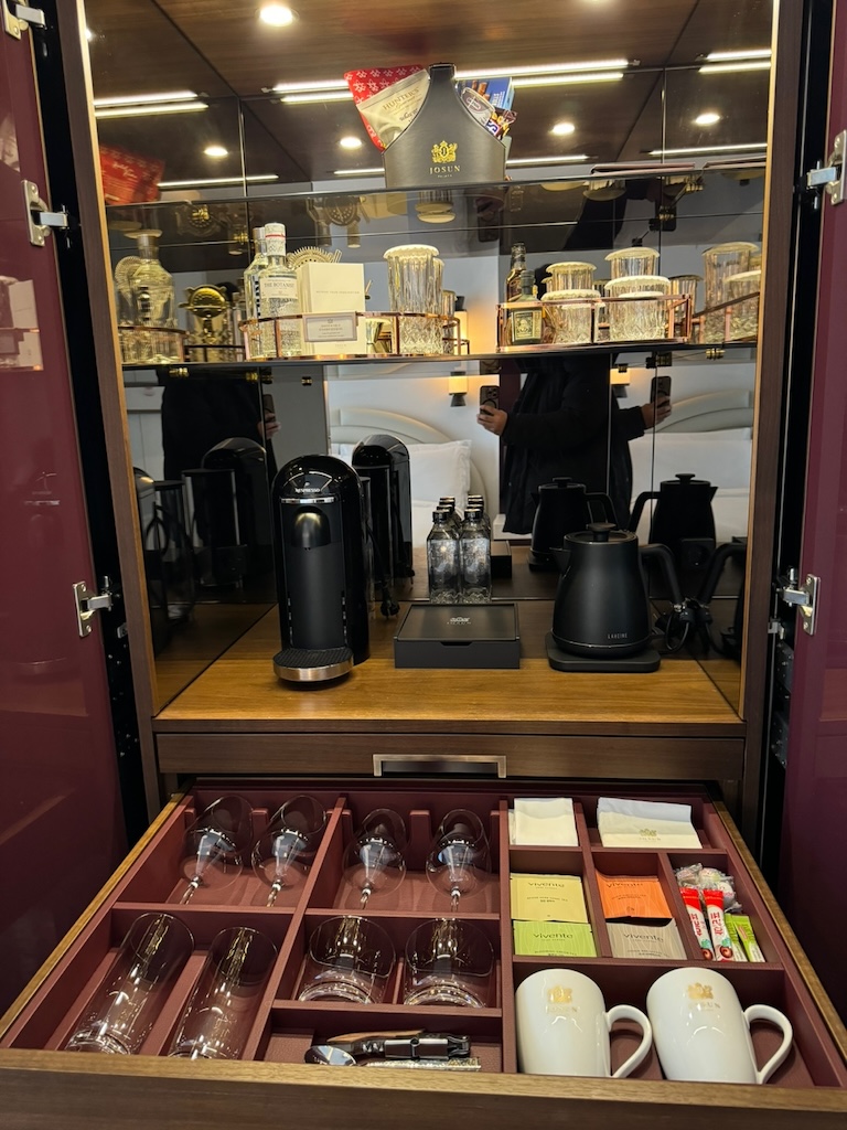 a glass case with glasses and cups