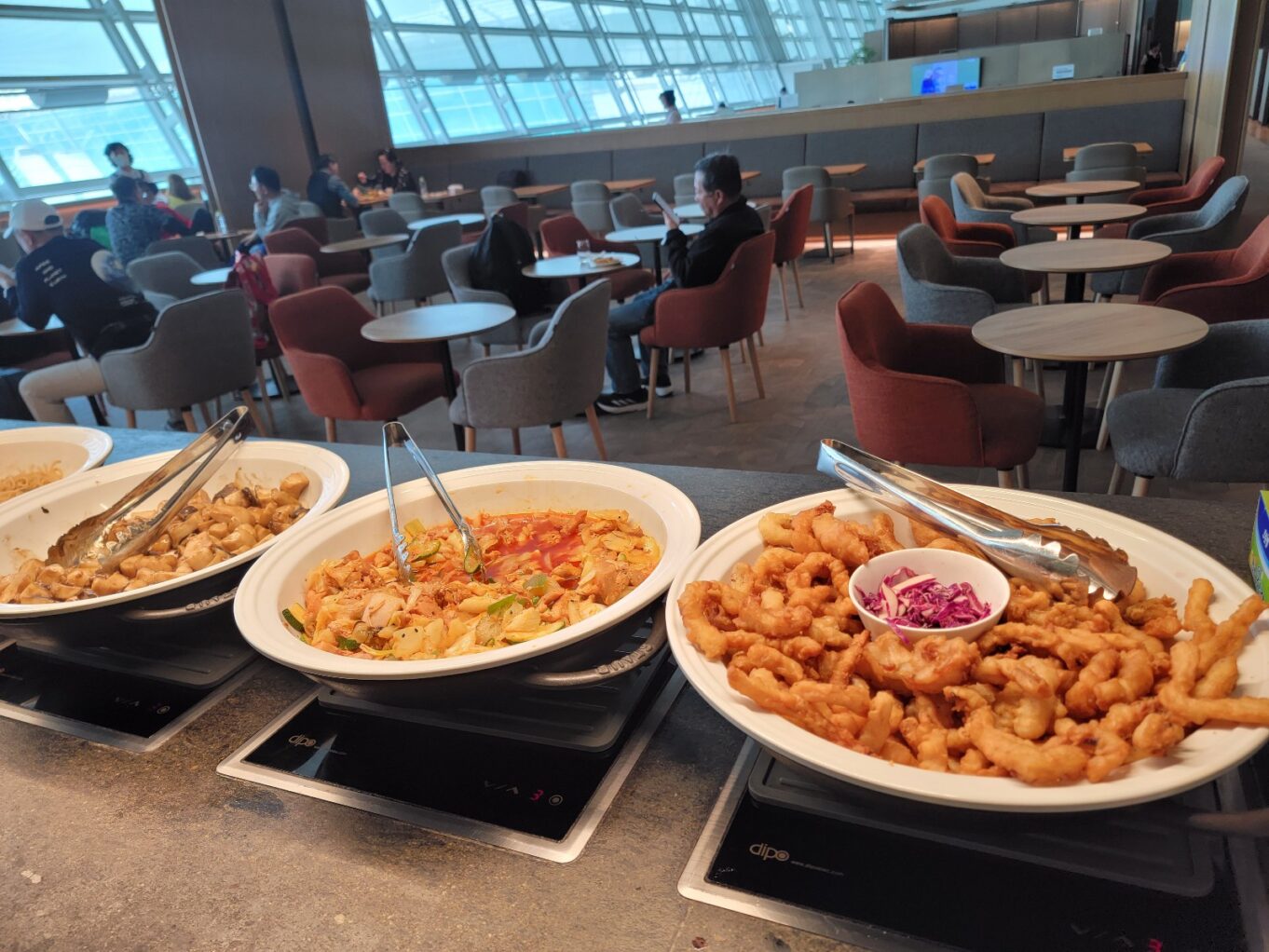 a large room with many plates of food on the table