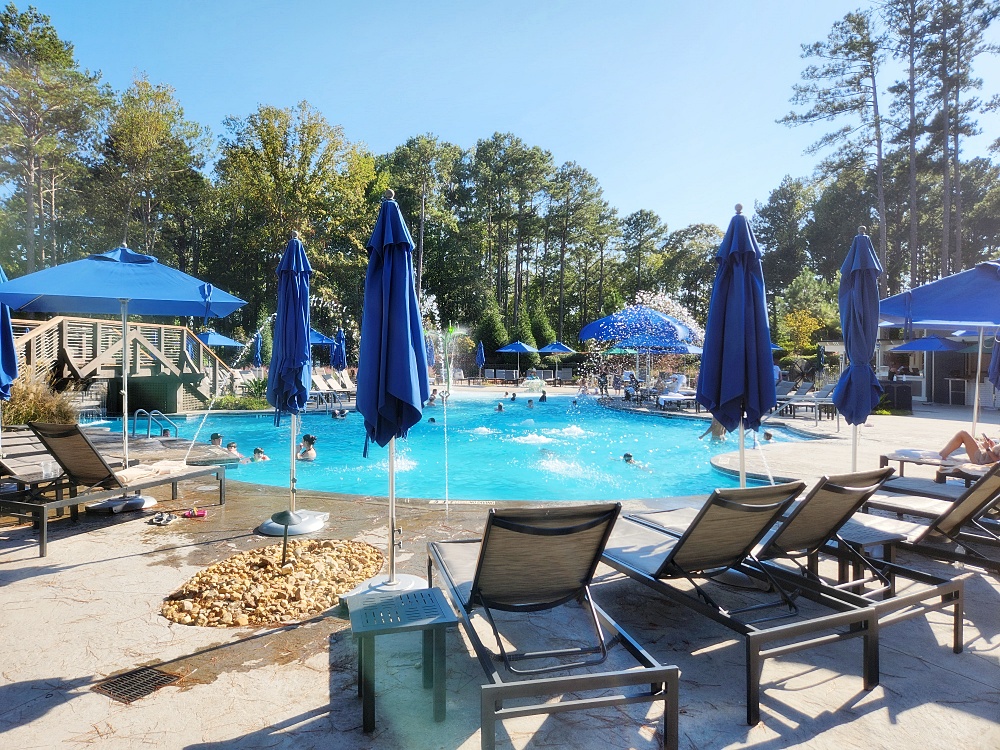 a pool with chairs and umbrellas